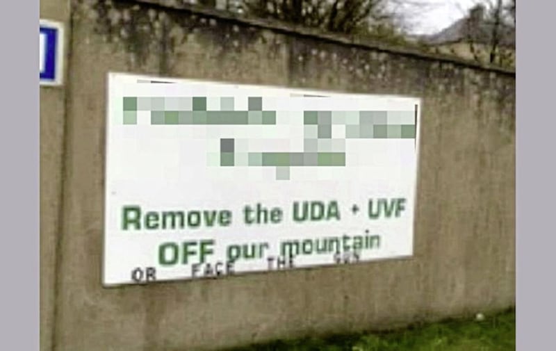 A sign erected in April 2016 placed at the entrance to QIH headquarters saying &quot;remove the UDA + UVF off our mountain or face the gun&quot;. QIH described it as &quot;clearly an attempt to inflame local republican paramilitary sympathisers to take action again the individuals named&quot;. 