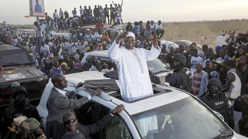 Gambian President Adama Barrow waves as he rides his motorcade through crowds of hundreds of thousands after arriving at Banjul airport in Gambia on Thursday after flying in from Dakar, Senegal. Picture by Jerome Delay, AP 