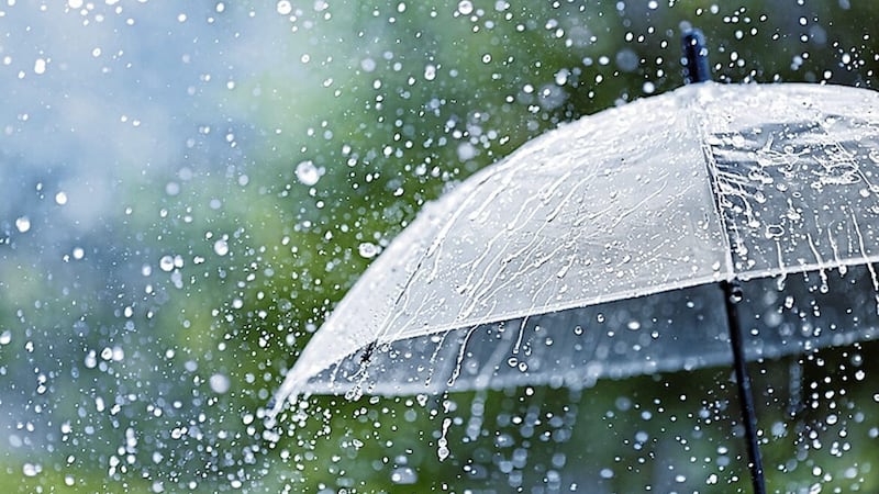 Transparent umbrella under heavy rain against water drops splash background. Rainy weather concept.. 