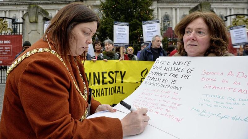 Belfast Lord Mayor Deirdre Hargey signs a letter of support during the protest at the City Hall in Belfast to mark International Migrants Day. Picture Mark Marlow 