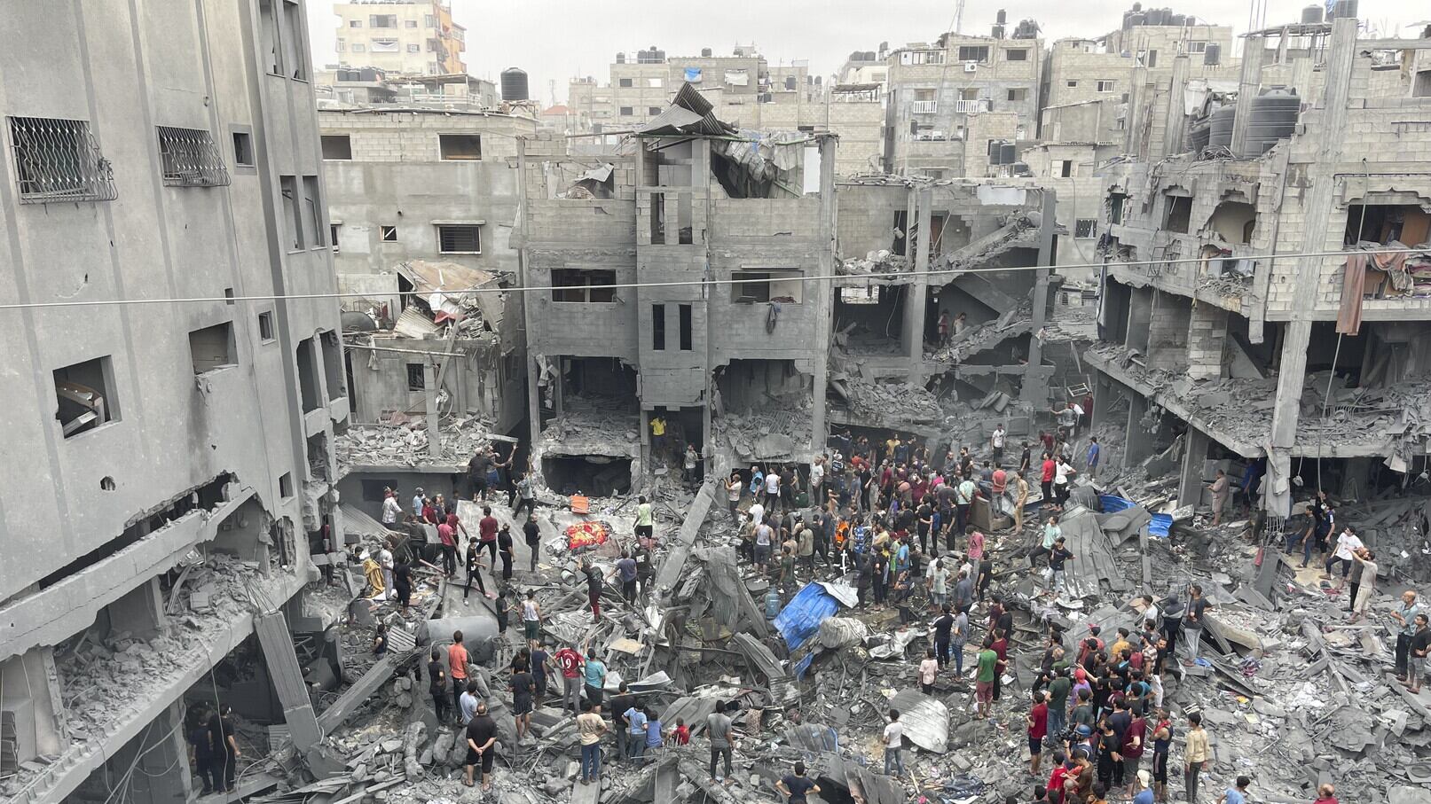Palestinians look for survivors after an Israeli air strike on buildings at Shati refugee camp (AP)