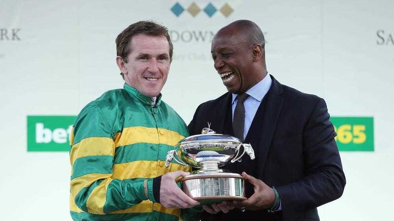 Ian Wright presents Tony McCoy with the Champions Jockey trophy during the jump finale at Sandown Racecourse, Surrey, in April. Picture by&nbsp;David Davies, PA Wire