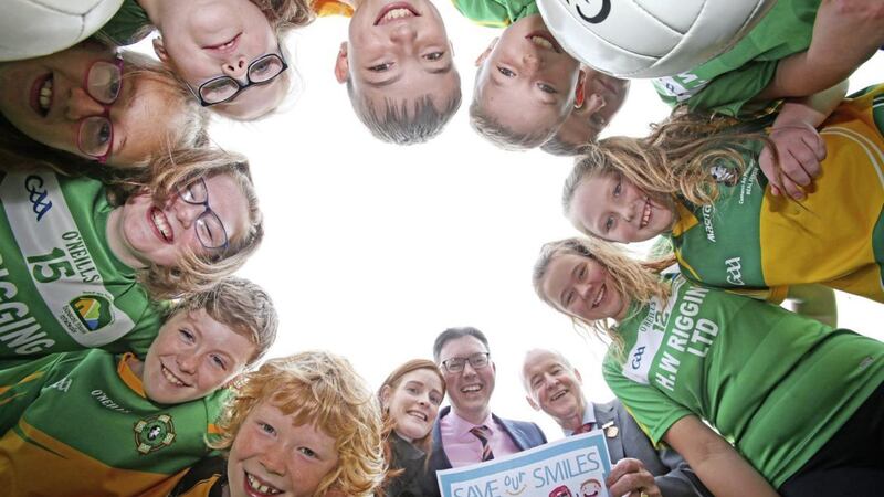 Pictured at the Save our Smiles Campaign launch are children from Bun Scoil Bheann Mhadagain, Belfast along with Bernie Fox (Ulster GAA Child Protection manager), Irish News marketing manager John Brolly and Michael Hasson (Ulster GAA president). Picture by Mal McCann