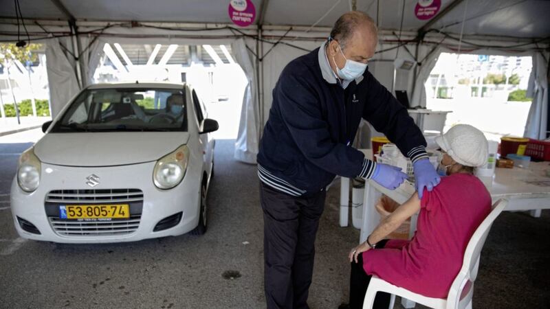 An Israeli woman receives a Covid-19 jab at a drive-in vaccination centre in the northern Israeli city of Haifa. Israel is leading the world in terms of vaccine roll-out; an international group of bishops has urged the international community to &#39;hold Israel accountable for its moral, legal and humanitarian responsibility to make Covid-19 vaccines accessible for Palestinians in the West Bank and Gaza&#39;. Picture by AP Photo/Sebastian Scheiner 