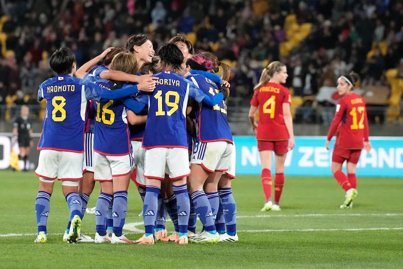 Japan’s Mina Tanaka celebrates with team-mates after scoring against Spain