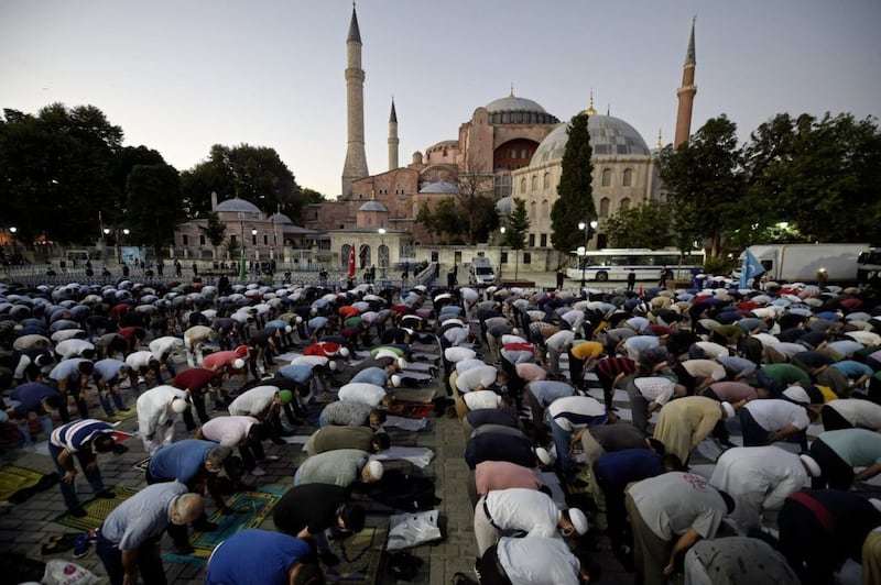 Muslims offer their evening prayers outside Hagia Sophia in Istanbul. Following a court ruling, Turkey&#39;s president Recep Tayyip Erdogan has ordered that it be turned back into a Mosque. Picture by AP Photo/Emrah Gurel 