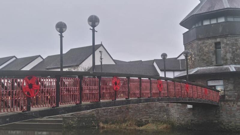 Knitted remembrance poppies decorate a bridge in Haverfordwest ahead of Armistice Day