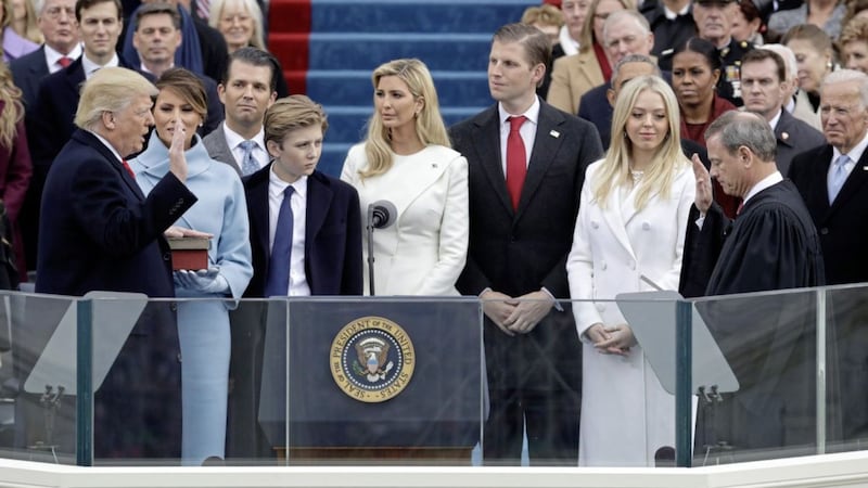 Donald Trump is sworn in as the 45th president of the US by Chief Justice John Roberts as Melania Trump and his family looks on. Picture by Patrick Semansky, Associated Press 