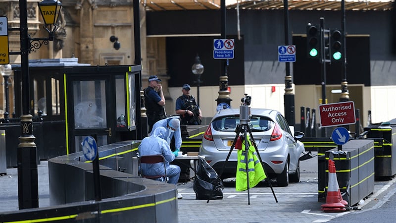 &nbsp;Forensic officers by the car that crashed into security barriers outside the Houses of Parliament, Westminster, London. Picture by&nbsp;Stefan Rousseau, PA Wire