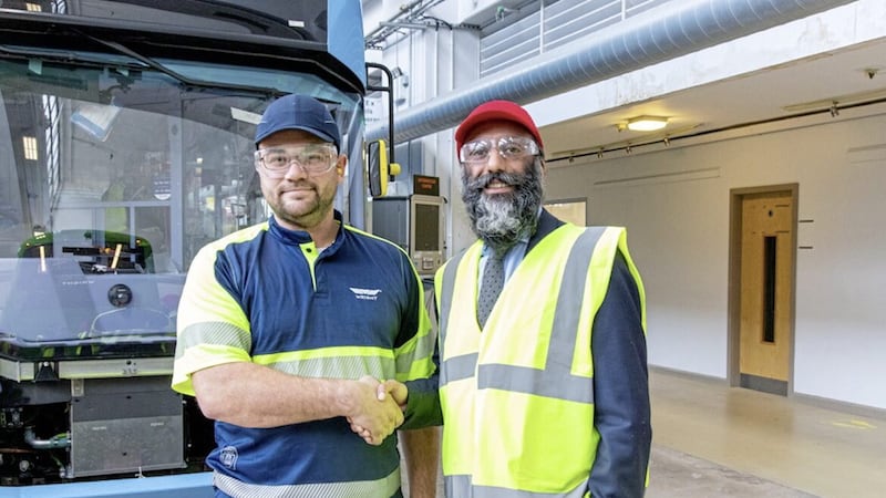 Wrightbus chief executive Buta Atwal (right) welcomes the company's 1,000th employee Matthew Hill onto the shop floor in Ballymena. 