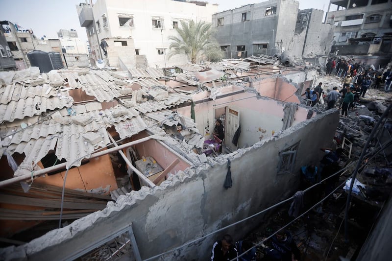 Palestinians look at destruction after the Israeli bombing In Khan Younis refugee camp in Gaza Strip