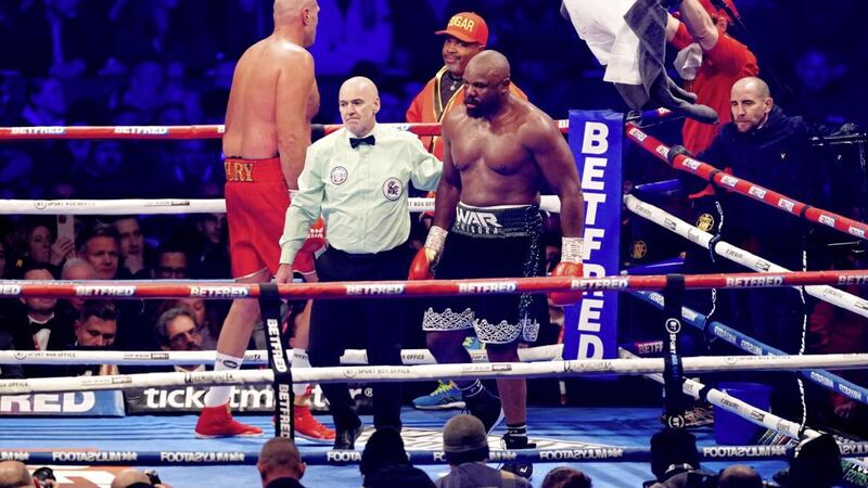 A defeated Dereck Chisora is led back to his corner after referee Victor Loughlin called a halt to his world heavyweight showdown with Tyson Fury last Saturday night. Picture by PA 