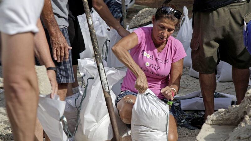 Kimberly Wraight fills her sandbag at Lealman Community Park, in St Petersburg, Florida PICTURE: Lara Cerri/The Tampa Bay Times via AP) 