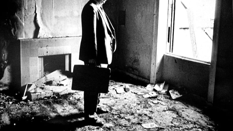 Gerry Fitt standing in the burnt out remains of his home on the Antrim Road in Belfast. Picture: Alan Lewis
