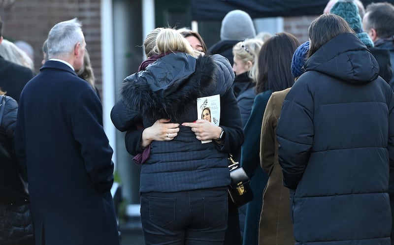 Mourners embrace during the funeral of murder victim Natalie McNally at her family home in Lurgan 