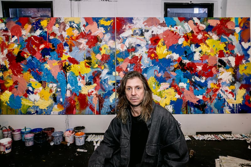 Robyn Ward pictured beside one of his large-scale paintings