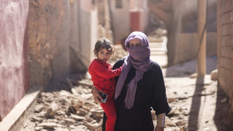 A woman and her daughter stand outside her home after the earthquake in Moulay Ibrahim village (Mosa’ab Elshamy/AP/PA)