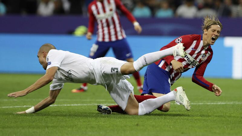 Atletico's Fernando Torres is sent sprawling by Real Madrid's Pepe during Saturday night's Champions League final at the San Siro<br />Picture by AP
