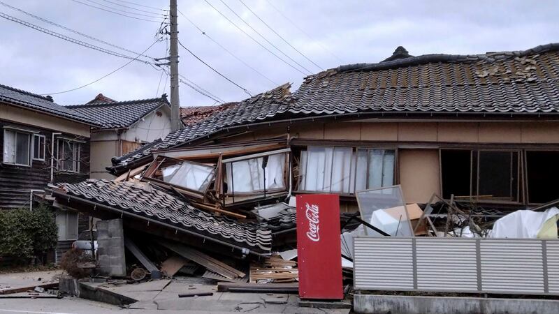 Japan issued tsunami alerts and ordered evacuations on Monday following a series of earthquakes which started a fire and trapped people under rubble on the west coast of its main island (Kyodo News/AP)