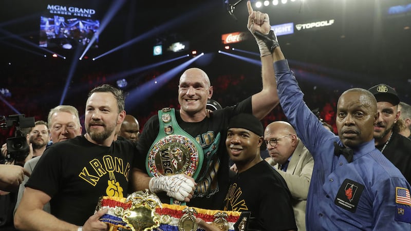 Tyson Fury is crowned WBC heavyweight champion on  Saturday, Feb 22, 2020, in Las Vegas after stopping Deontay Wilder inside seven rounds. Irish fighter Andy Lee (left) holds Tyson's prize belt.<br />(AP Photo/Isaac Brekken) &nbsp;