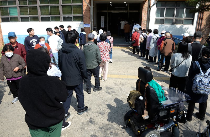 People wait in line to cast their votes (Bae Byung-soo/Newsis via AP)