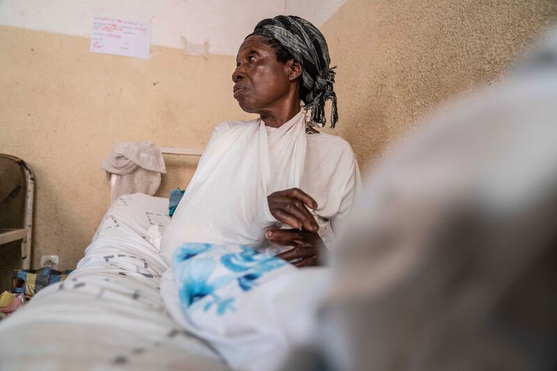 An elderly woman who was wounded in ongoing fighting between M23 rebel forces and Congolese forces in the Sake region of Congo sits on her hospital bed (Moses Sawasawa/AP)