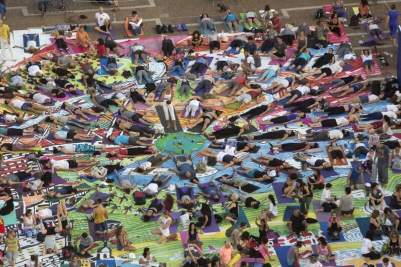 Israelis practice yoga at the Rabin square in Tel Aviv, Israel, Wednesday, June 21, 2017 (Sebastian Scheiner/AP)