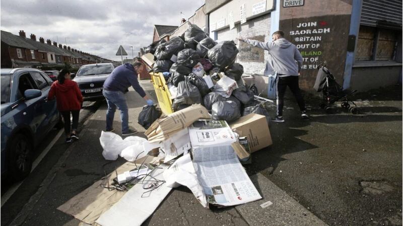 Fifteen skips of rubbish were lifted in ten minutes in Ardoyne in north Belfast yesterday. Picture by Hugh Russell. 