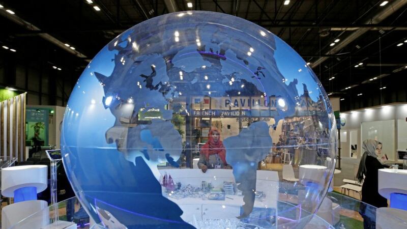 A woman looks at a world globe at the COP25 climate talks congress in Madrid, Spain 