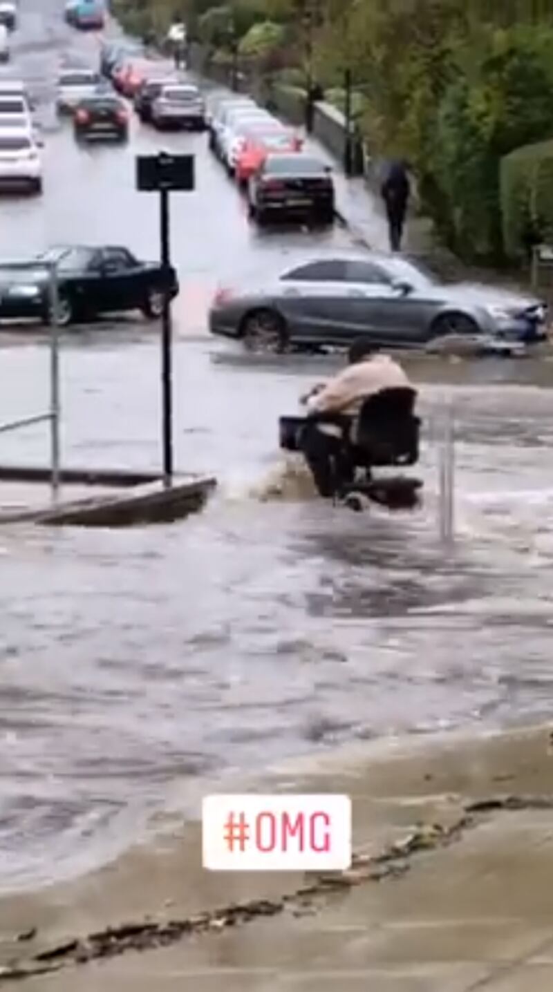 The woman driving through the floods