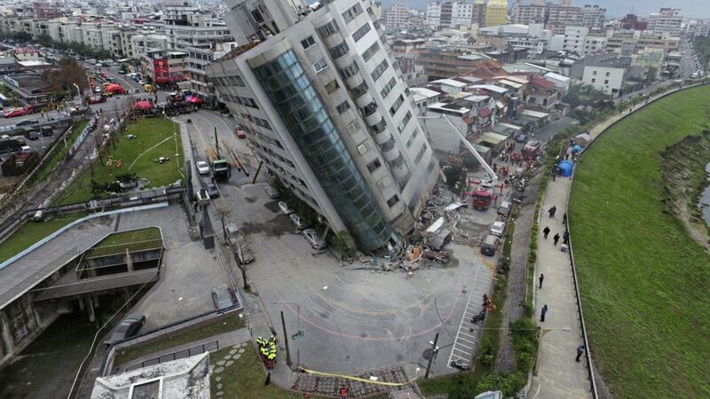 A residential building leans on a collapsed first floor after a strong earthquake hit near Taiwan&#39;s east coast and killed at least four people PICTURE: Central News Agency via AP 