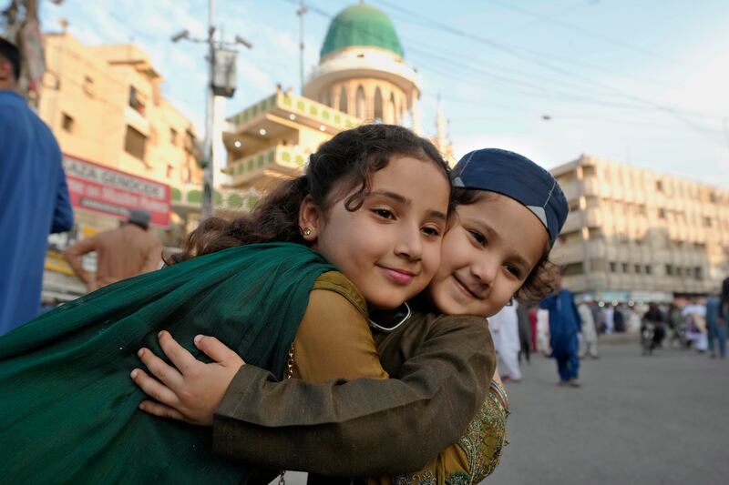 Muslim children share Eid greetings in Karachi, Pakistan (Fareed Khan/AP)