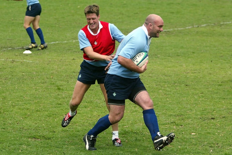John Hayes slips through the tackle of Ronan O'Gara during Ireland's training session at the East Coast Grammar school grounds near Gosford, New South Wales on Tuesday October 14 2003. &nbsp;