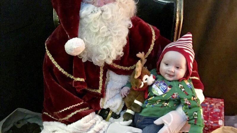 Happy Christmas: Little Indy enjoys a trip to see Santa Claus 