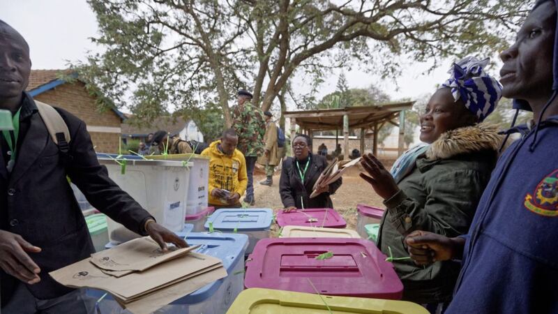 Electoral workers stand by ballot boxes stacked up at a collection centre in Nairobi, Kenya, on Wednesday. Picture by Ben Curtis/AP 