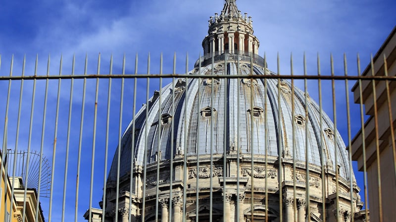 St Peter's Dome is framed by the bars of the Perugino gate at the Vatican in Rome. Picture by Gregorio Borgia, AP&nbsp;