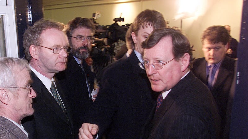 Ulster Unionist Leader David Trimble (right) is ushered past Sinn Fein Leader Gerry Adams (3rd left) and Martin McGuinness (2nd left), after talks broke up at Hillsborough Castle.