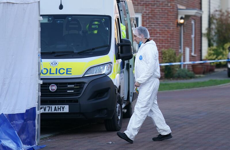 A forensic investigator outside a house in Costessey near Norwich