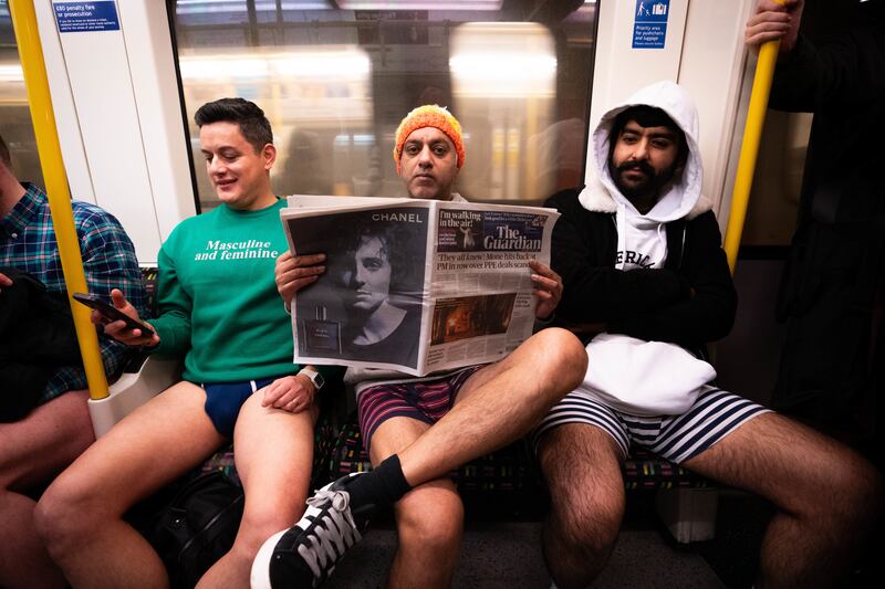 People riding a Circle line Tube as they take part in the annual No Trousers Tube Ride in London