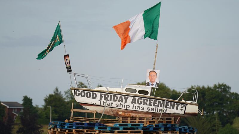A pyre with a boat on top, with a picture of Taoiseach Leo Varadkar and a banner that reads ‘Good Friday Agreement? That ship has sailed’, before it is set alight in Moygashel, Co Tyrone (Niall Carson/PA)