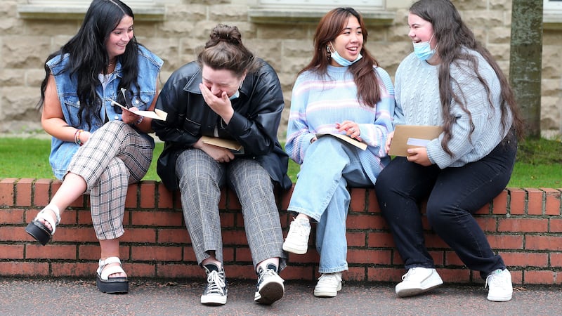 Pupils at St Dominic's in Belfast share a joke as they look over their A level results
