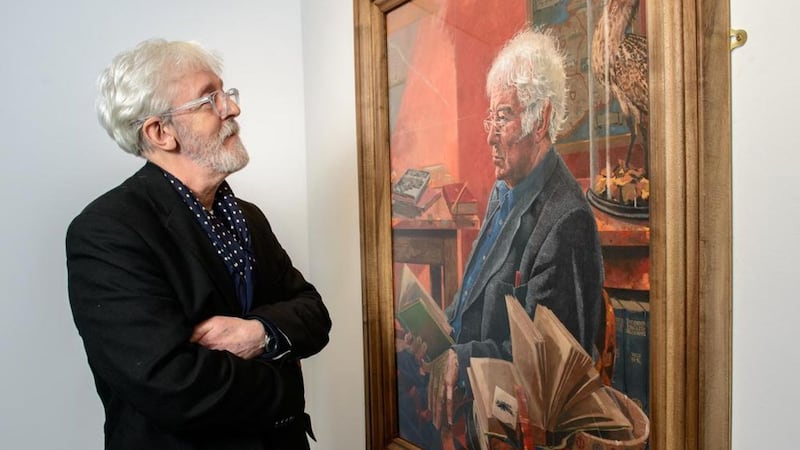 Artist Richard Morgan alongside his portrait of famed poet Seamus Heaney 