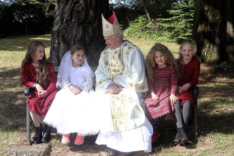 Bishop of Down and Connor Noel Treanor with local children at Saul, Co Down on Sunday. Picture by Bill Smyth. 