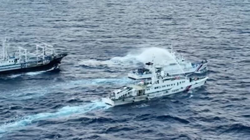 A Chinese coast guard ship uses water cannon against Philippine coast guard patrol ship, BRP Cabra as it approaches Second Thomas Shoal (Philippine Coast Guard via AP)