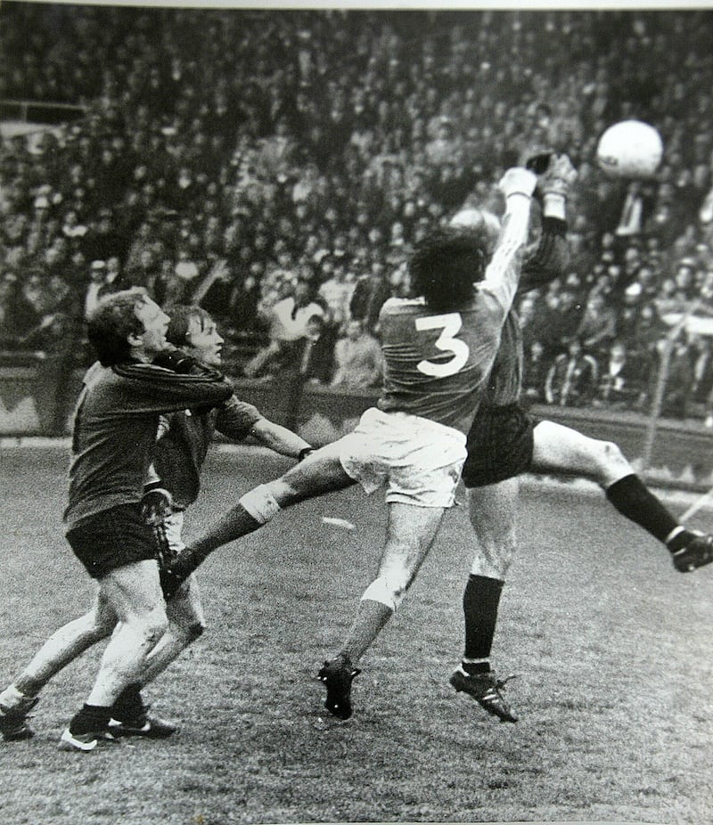 The thick of the action. Jim McKerr in an aerial duel with Down full-forward Ambrose Rogers