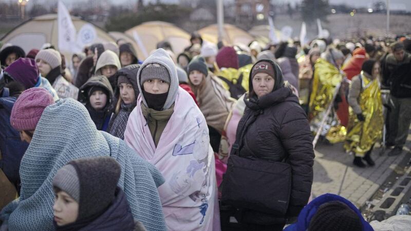 Refugees wait in a crowd for transportation after fleeing from the Ukraine and arriving at the Medyka border crossing in Poland. Many Ukrainian civilians who have escaped the country could end up in Northern Ireland, looking for a job 