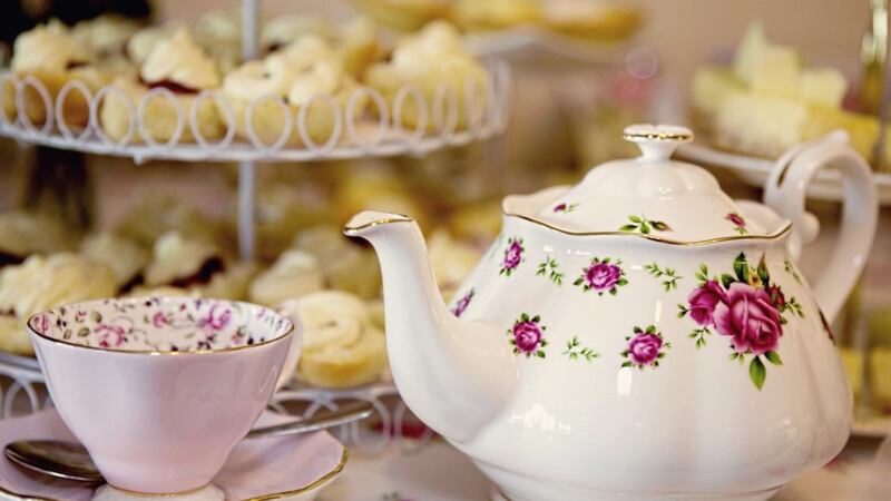 Teapot, cup and saucer and food for a high tea or morning or afternoon tea - elegant 