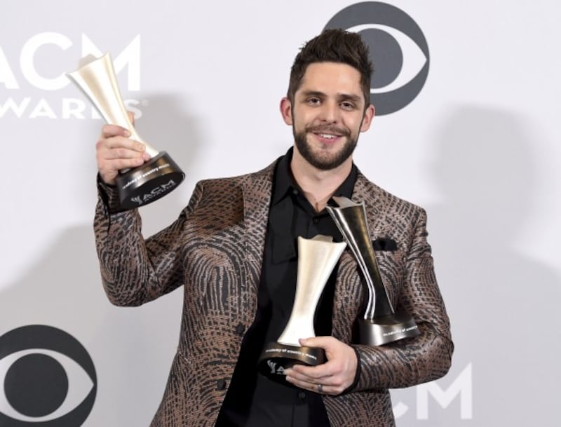 Thomas Rhett poses in the press room with his awards for artist and songwriter for song of the year for 