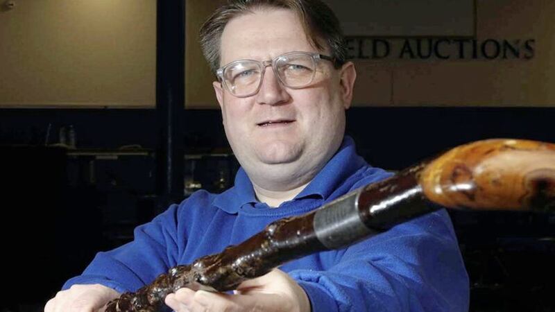 Karl Bennett, of Bloomfield Auctions in east Belfast, with the walking stick which belonged to James Craig 