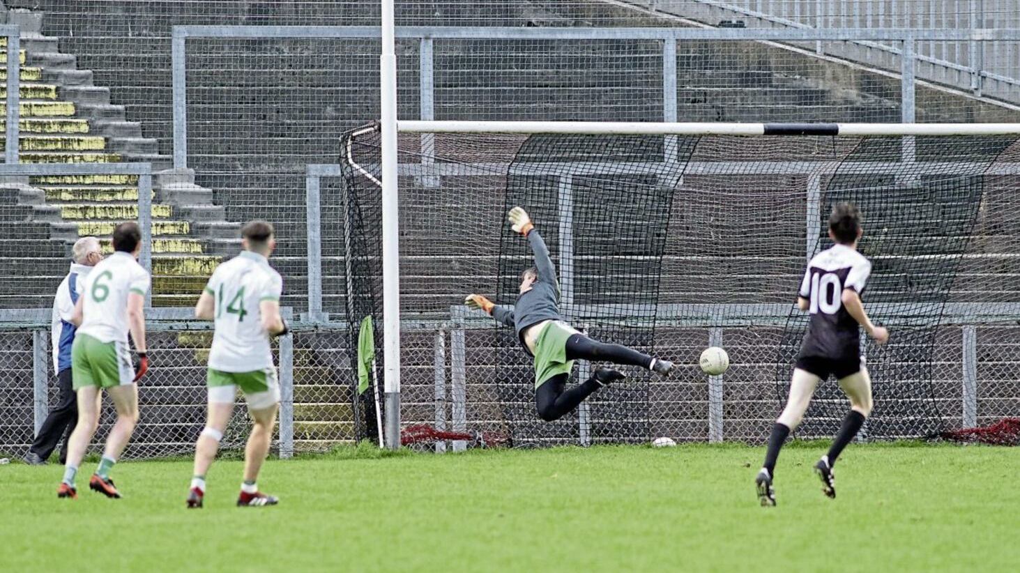 Burren goalkeeper Cathal Murdock can’t keep out an early goal from Kilcoo’s Jerome Johnston (out of shot) during yesterday’s Morgan Fuels Down SFC round three encounter at Pairc Esler. The Magpies won by five points